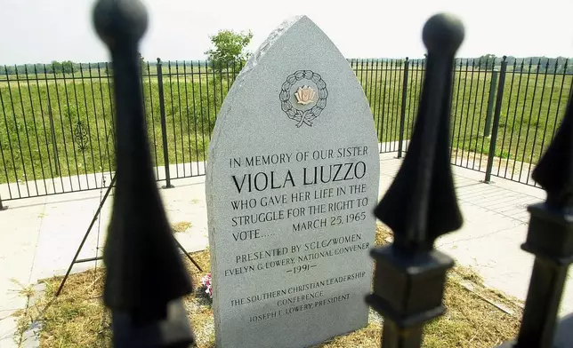 FILE - An iron fence surrounds the memorial to civil rights activist Viola Liuzzo on Friday, July 7, 2000, near Lowndesboro, Ala., on U.S. 80. (AP Photo/Dave Martin, File)