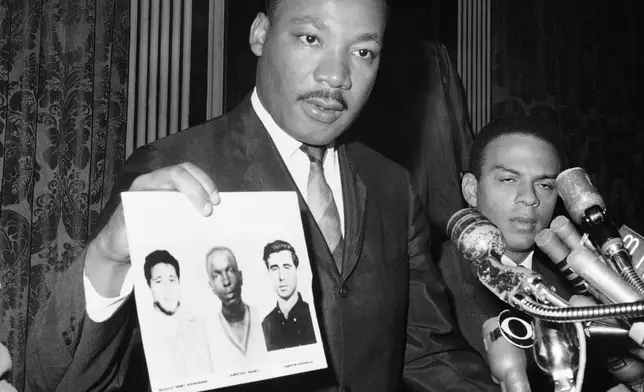 FILE - In this file photo civil rights leader Dr. Martin Luther King displays pictures of three civil rights workers, who were slain in Mississippi the summer before, from left Michael Schwerner, James Chaney, and Andrew Goodman, at a news conference in New York, Dec. 4, 1964, where he commended the FBI for its arrests in Mississippi in connection with the slayings. (AP Photo/JL, File)
