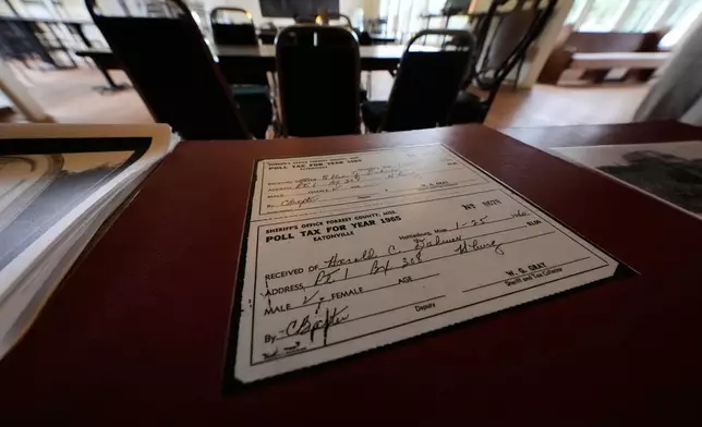 A copy of a poll tax receipt sits in the old schoolhouse meeting place, as part of the legacy of Vernon Dahmer, Sr., who was killed when the Ku Klux Klan firebombed the family home 1966, in Hattiesburg, Miss., Wednesday, June 3, 2026. (AP Photo/Gerald Herbert)