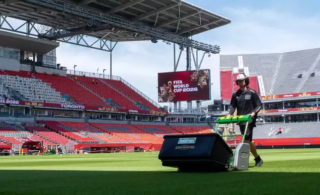 A worker mows the grass at Toronto Stadium, Thursday June 4, 2026, in Toronto, in preparation for World Cup soccer tournament. (Frank Gunn/The Canadian Press via AP)