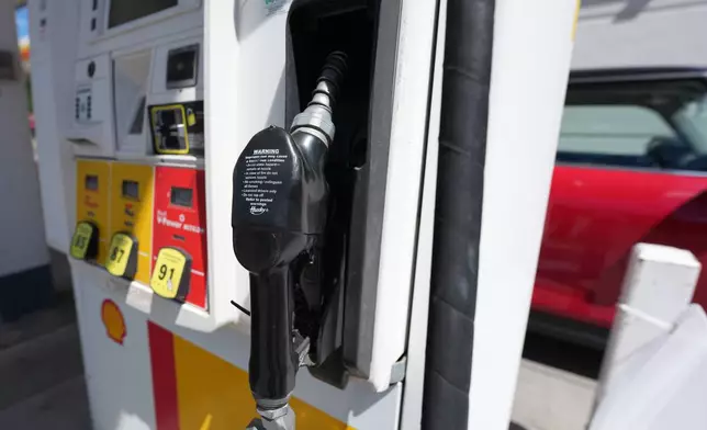 The handle stands at the ready on a pump with the three grades of gasoline available at a pump at Shell station Wednesday, June 10, 2026, in Englewood, Colo. (AP Photo/David Zalubowski)