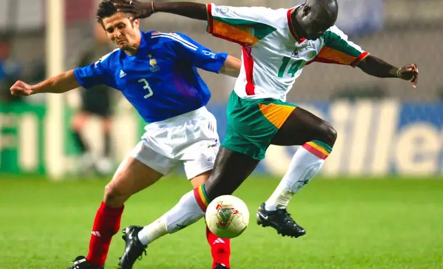 FILE - Senegal's Moussa Ndiaye, right, and France's Bixente Lizarazu go for the ball during their World Cup Group A soccer match at the World Cup stadium in Seoul, May 31, 2002. (AP Photo/Lionel Cironneau, File)