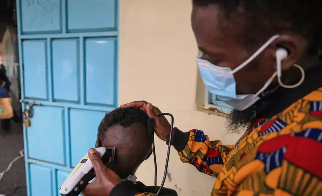 A barber shaves a patients hair during a grooming session at the largest mental health referral hospital, Mathari in Nairobi, Kenya, Tuesday, June 30, 2026. (AP Photo/Andrew Kasuku)