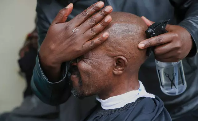 A barber shaves a patients hair during a grooming session at the largest mental health referral hospital, Mathari in Nairobi, Kenya, Tuesday, June 30, 2026. (AP Photo/Andrew Kasuku)