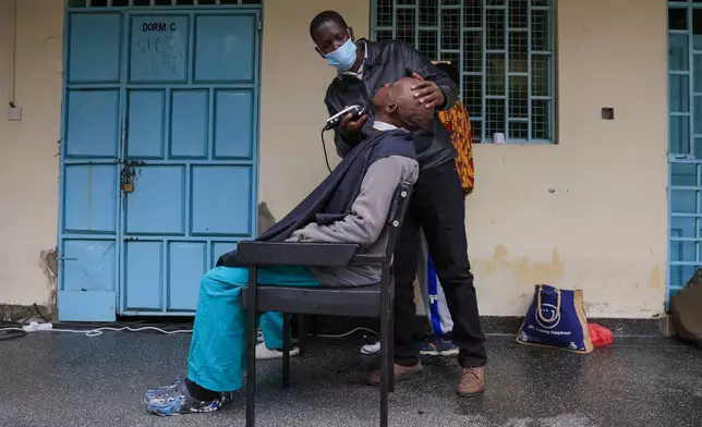 A barber shave a patients hair during a grooming session at the largest mental health referral hospital, Mathari in Nairobi, Kenya, Tuesday, June 30, 2026. (AP Photo/Andrew Kasuku)
