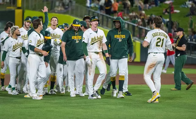 The Athletics celebrate winning a baseball game against the Los Angeles Angels in West Sacramento, Calif., Friday, June 19, 2026. (AP Photo/Nic Coury)