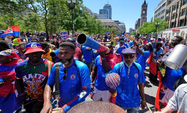 Haiti supporters march on a street in central Boston, Mass,, ahead of the World Cup Group C soccer match between Haiti and Scotland in Foxborough, Saturday, June 13, 2026. (AP Photo/Martin Meissner)