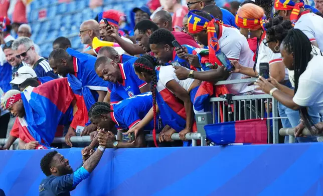 Haiti's Josue Casimir reacts with fans ahead of the World Cup Group C soccer match between Haiti and Scotland in Foxborough, Mass., near Boston, Saturday, June 13, 2026. (AP Photo/Martin Meissner)