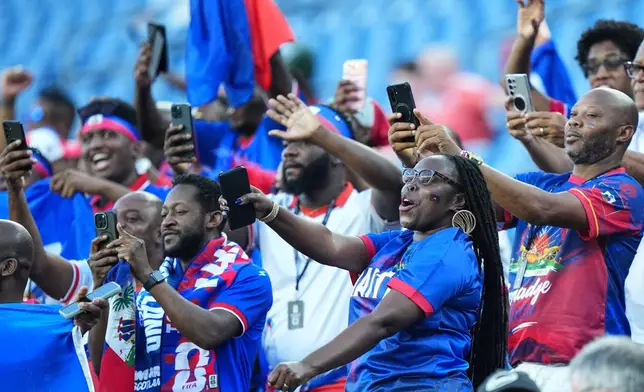 Haiti supporters react ahead of the World Cup Group C soccer match between Haiti and Scotland in Foxborough, Mass., near Boston, Saturday, June 13, 2026. (AP Photo/Martin Meissner)