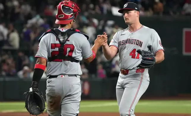 Washington Nationals catcher Keibert Ruiz, left, and pitcher Brad Lord, right, celebrate after their team defeated the Arizona Diamondbacks in a baseball game, Saturday, June 6, 2026, in Phoenix. (AP Photo/Rick Scuteri)