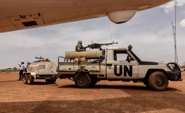 UN peacekeepers stand guard of a UN flight refuelling on the tarmac of the Birao Airport in Central African Republic, Wednesday, March 25, 2026. (AP Photo/Caitlin Kelly)