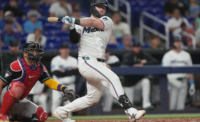 Miami Marlins Liam Hicks (34) hits a triple to right field during the third inning of a baseball game against the Arizona Diamondbacks Wednesday, June 10, 2026, in Miami. (AP Photo/Marta Lavandier)