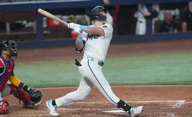 Miami Marlins' Kyle Stowers hits a three-run home run to right field during the fourth inning of a baseball game against the Arizona Diamondbacks Wednesday, June 10, 2026, in Miami. (AP Photo/Marta Lavandier)