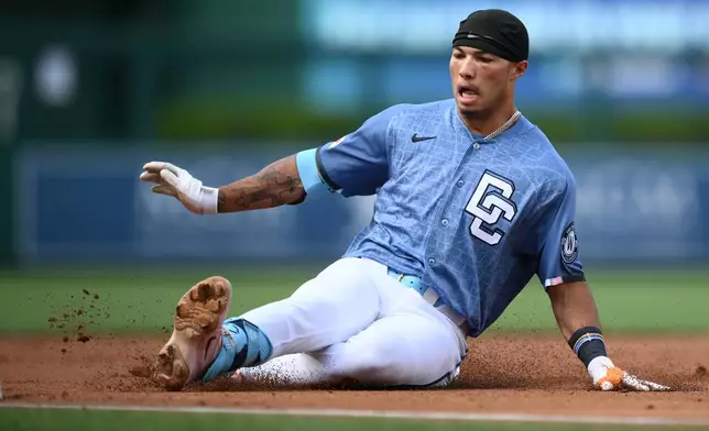 Washington Nationals' Daylen Lile slides to third base on his triple during the first inning of a baseball game against the Seattle Mariners, Saturday, June 13, 2026, in Washington. (AP Photo/Nick Wass)