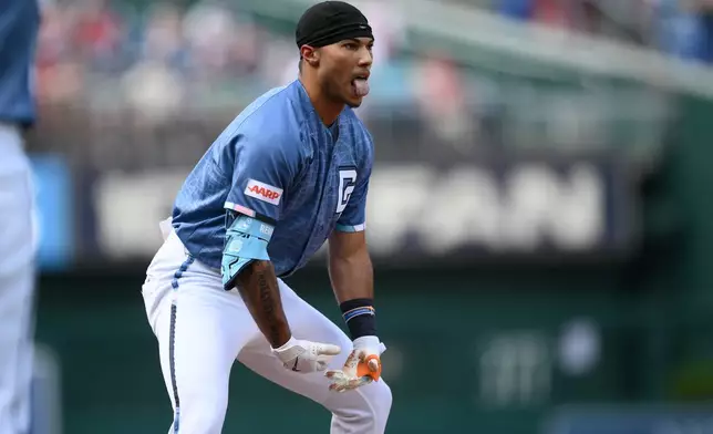 Washington Nationals' Daylen Lile reacts at third base after he tripled during the first inning of a baseball game against the Seattle Mariners, Saturday, June 13, 2026, in Washington. (AP Photo/Nick Wass)