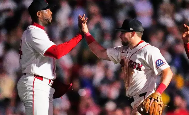 Boston Red Sox's Aroldis Chapman, left, celebrates with Caleb Durbin, right, after their team defeated the New York Yankees, Thursday, June 25, 2026, in Boston. (AP Photo/Charles Krupa)