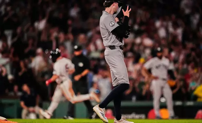 New York Yankees' Cam Schlittler walks off the mound as Boston Red Sox's Caleb Durbin rounds the bases on a two-run home run in the fifth inning of a baseball game, Thursday, June 25, 2026, in Boston. (AP Photo/Charles Krupa)