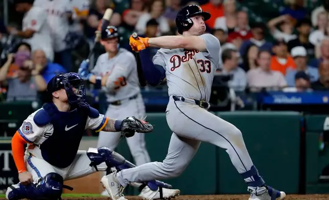 Detroit Tigers' Colt Keith (33) watches his second two-run home run of a baseball game in front of Houston Astros catcher Christian Vazquez, left, during the seventh inning Monday, June 15, 2026, in Houston. (AP Photo/Michael Wyke)