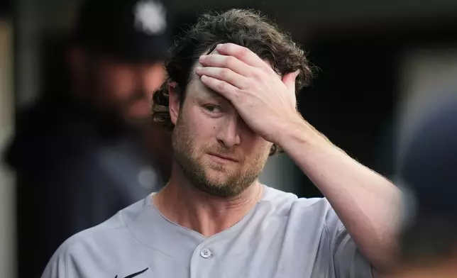 New York Yankees pitcher Gerrit Cole walks in the dugout against the Detroit Tigers during the fifth inning of a baseball game Monday, June 22, 2026, in Detroit. (AP Photo/Paul Sancya)