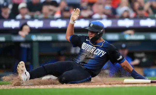 Detroit Tigers' Hao-Yu Lee slides safely into home plate against the New York Yankees during the fourth inning of a baseball game Monday, June 22, 2026, in Detroit. (AP Photo/Paul Sancya)