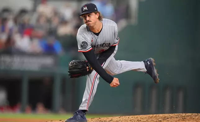 Minnesota Twins starting pitcher Joe Ryan follows through on a throw during the third inning of a baseball game against the Texas Rangers, Thursday, June 18, 2026, in Arlington, Texas. (AP Photo/LM Otero)