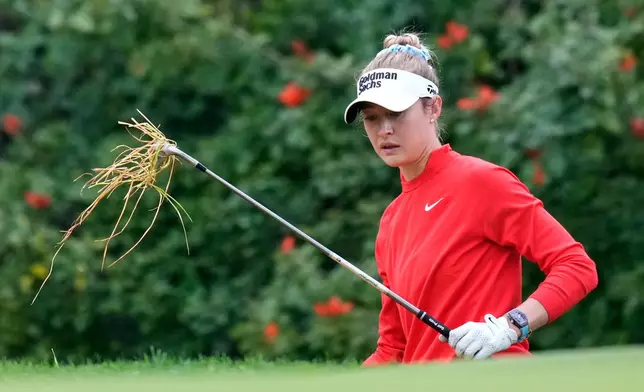 Grass hangs from the club of Nelly Korda on the 12th hole during the first round of the U.S. Women's Open golf tournament Thursday, June 4, 2026, in the Pacific Palisades area of Los Angeles. (AP Photo/Ashley Landis)