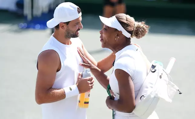 Serena Williams of the U.S. speaks with Grigor Dimitrov of Bulgaria, ahead of the Wimbledon Tennis Championships, at the All England Lawn Tennis and Croquet Club, in London, Saturday June 27, 2026. (John Walton/PA via AP)