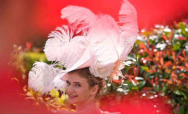 Racegoers pose for photographs on the first day of the Royal Ascot horse race meeting in Ascot, England, Tuesday, June 16, 2026.(AP Photo/Kin Cheung)