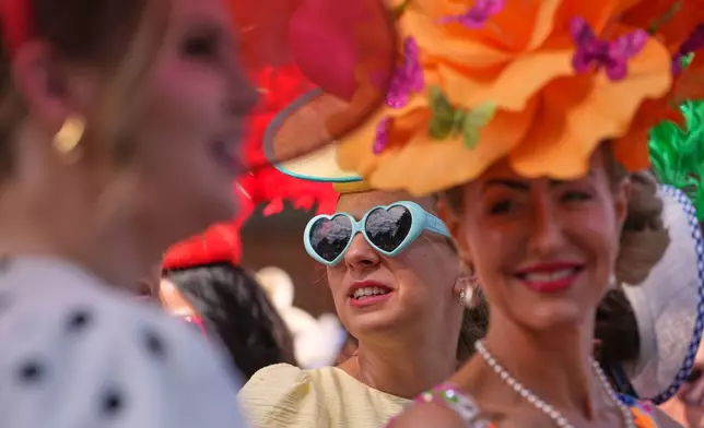 Racegoers queue at the entrance as they arrive on the first day of the Royal Ascot horse race meeting in Ascot, England, Tuesday, June 16, 2026.(AP Photo/Kin Cheung)