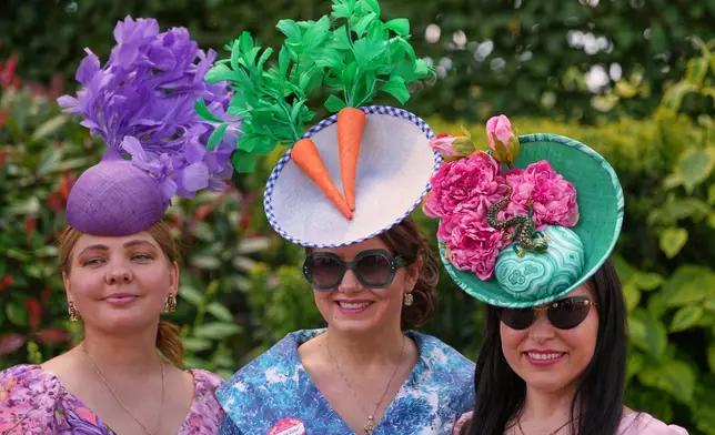 Racegoers pose for picyures on the first day of the Royal Ascot horse race meeting in Ascot, England, Tuesday, June 16, 2026.(AP Photo/Kin Cheung)