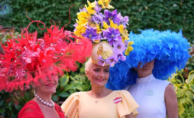 Racegoers pose for picyures on the first day of the Royal Ascot horse race meeting in Ascot, England, Tuesday, June 16, 2026.(AP Photo/Kin Cheung)