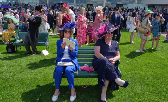 Racegoers take a break on the first day of the Royal Ascot horse race meeting in Ascot, England, Tuesday, June 16, 2026.(AP Photo/Kin Cheung)