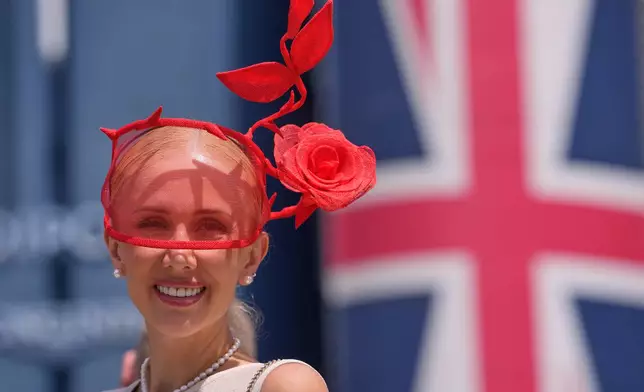 A racegoer poses for photographers on the first day of the Royal Ascot horse race meeting in Ascot, England, Tuesday, June 16, 2026.(AP Photo/Kin Cheung)