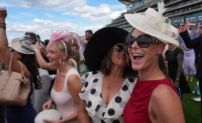 Racegoers react on the first day of the Royal Ascot horse race meeting in Ascot, England, Tuesday, June 16, 2026.(AP Photo/Kin Cheung)