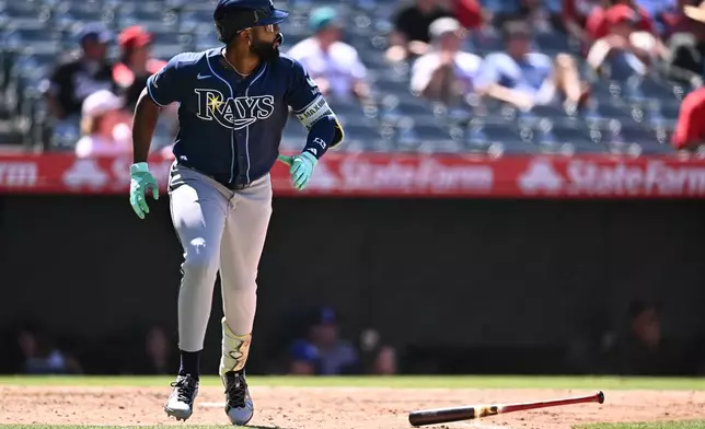 Tampa Bay Rays' Junior Caminero watches his home run during the eighth inning of a baseball game against the Los Angeles Angels, Sunday, June 14, 2026, in Anaheim, Calif. (AP Photo/William Liang)
