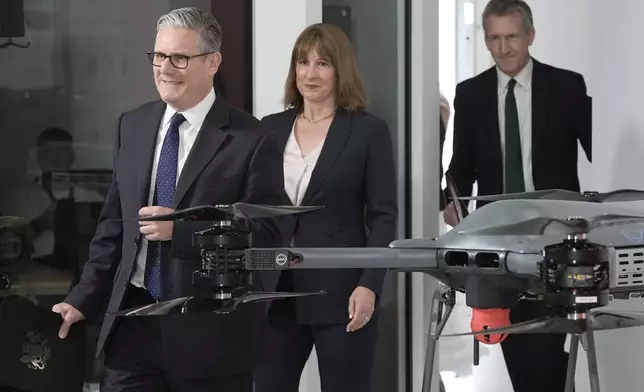 British Prime Minister Keir Starmer, left, followed by Chancellor of the Exchequer Rachel Reeves and Defense Secretary Dan Jarvis arrive for the announcement of a defense plan, in Berkshire, England, Tuesday, June 30, 2026. (Stefan Rousseau/Pool Photo via AP)