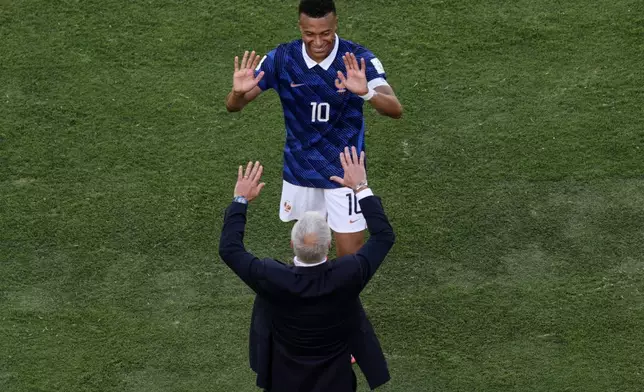 France head coach Didier Deschamps and Kylian Mbappe celebrate after the third goal during the World Cup Group I soccer match between France and Senegal in East Rutherford, N.J., near New York, Tuesday, June 16, 2026. (AP Photo/Adam Hunger)