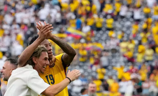 Ecuador head coach Sebastian Beccacece, left, celebrates with player Gonzalo Plata after the World Cup Group E soccer match against Germany in East Rutherford, N.J., near New York, Thursday, June 25, 2026. (AP Photo/Yuki Iwamura)