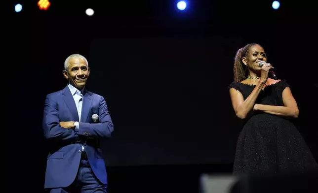 Former President Barack Obama and former first lady Michelle Obama on stage as they surprised administration and campaign alumni in Chicago at the ahead of the dedication ceremony of the Obama Presidential Center, Wednesday, June 17, 2026. (AP Photo/Pablo Martinez Monsivais, Pool)