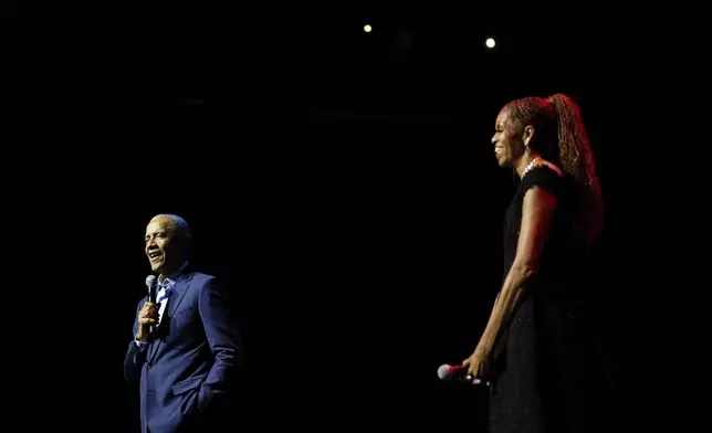 Former President Barack Obama and former first lady Michelle Obama on stage as they surprised administration and campaign alumni in Chicago ahead of the dedication ceremony of the Obama Presidential Center, Wednesday, June 17, 2026. (AP Photo/Pablo Martinez Monsivais, Pool)