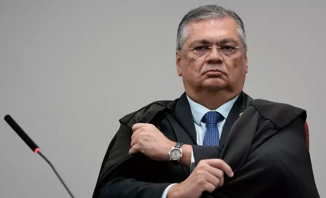 Justice Flavio Dino attends the trial of former Congressman Eduardo Bolsonaro at Brazil's Supreme Court in Brasilia, Tuesday, June 16, 2026. (AP Photo/Eraldo Peres)