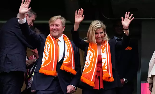 King Willem-Alexander and Queen Maxima of the Netherlands wave from the tribune before the World Cup Group F soccer match between the Netherlands and Sweden in Houston, Saturday, June 20, 2026. (AP Photo/Ashley Landis)