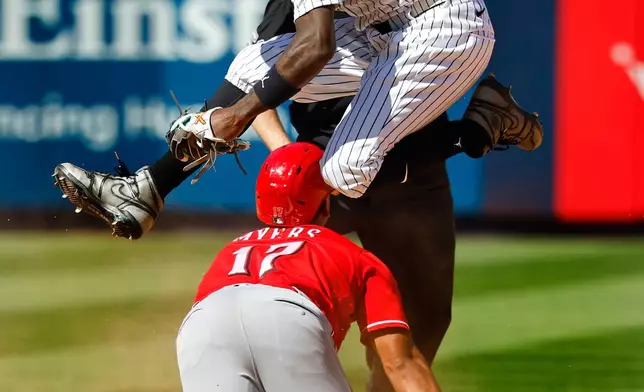 New York Yankees second baseman Jazz Chisholm Jr., top front, hurdles Cincinnati Reds' Dane Myers (17) during the eighth inning of a baseball game, Saturday, June 20, 2026, in New York. (AP Photo/Noah K. Murray)