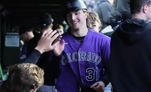 Colorado Rockies' Jake McCarthy celebrates with teammates after scoring on a one-run double by Willi Castro during the fourth inning of a baseball game against the Chicago Cubs in Chicago, Tuesday, June 16, 2026. (AP Photo/Nam Y. Huh)