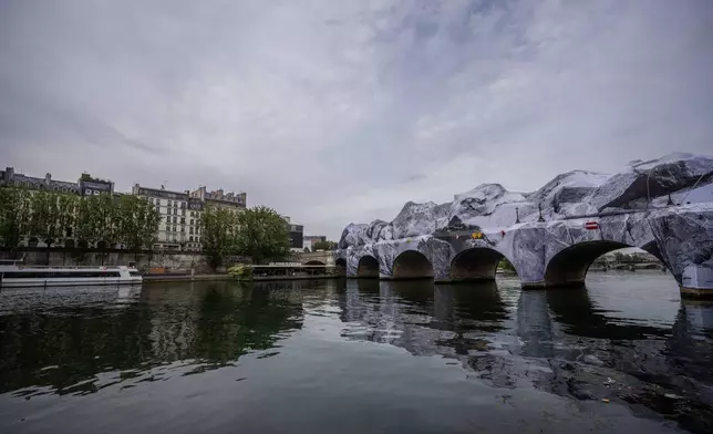 Artwork "The Pont Neuf Cave" by French street artist JR on the Pont Neuf bridge opens to the public from June 15 to 28, in Paris, Tuesday, June 16, 2026, in Paris. (AP Photo/Aurelien Morissard)