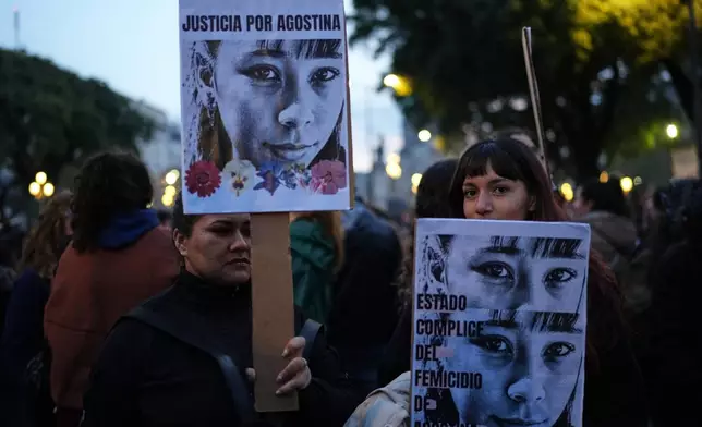 Demonstrators hold photos of 14-year-old Agostina Vega, who was murdered, during a march marking the anniversary of the "Ni Una Menos" (Not One Fewer) women's movement in Buenos Aires, Argentina, Wednesday, June 3, 2026. (AP Photo/Natacha Pisarenko)