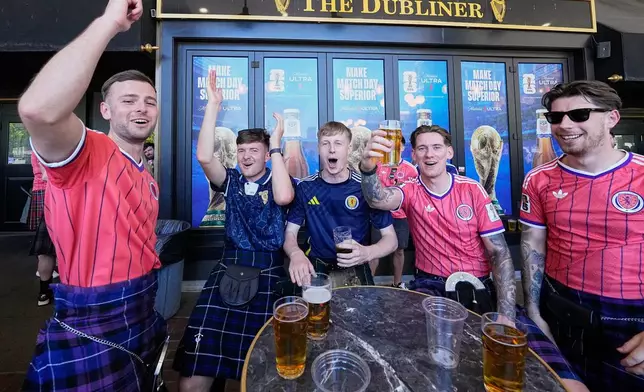 Scottish fans drink and sing at a pub in central Boston, Mass,, ahead of the World Cup Group C soccer match between Haiti and Scotland in Foxborough, Saturday, June 13, 2026. (AP Photo/Martin Meissner)