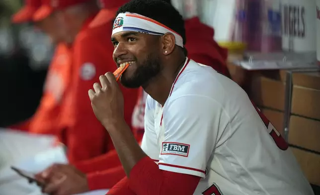 Los Angeles Angels pitcher Walbert Urena (57) smiles in the dugout after retiring the Houston Astros during the fourth inning in a baseball game Tuesday, June 9, 2026, in Anaheim, Calif. (AP Photo/Scott Strazzante)