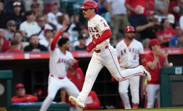 Los Angeles Angels Wade Meckler (53) scores on Jo Adell's two-run double against the Houston Astros during the second inning of a baseball game Tuesday, June 9, 2026, in Anaheim, Calif. (AP Photo/Scott Strazzante)