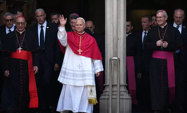 Pope Leo XIV waves to the cheering crowd after attending a midday prayer at the Cathedral of the Holy Cross and Saint Eulalia in Barcelona, Spain, Tuesday, June 9, 2026. (AP Photo/Emilio Morenatti)